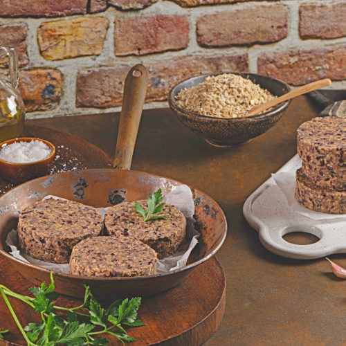 Raw black bean burgers in a pan